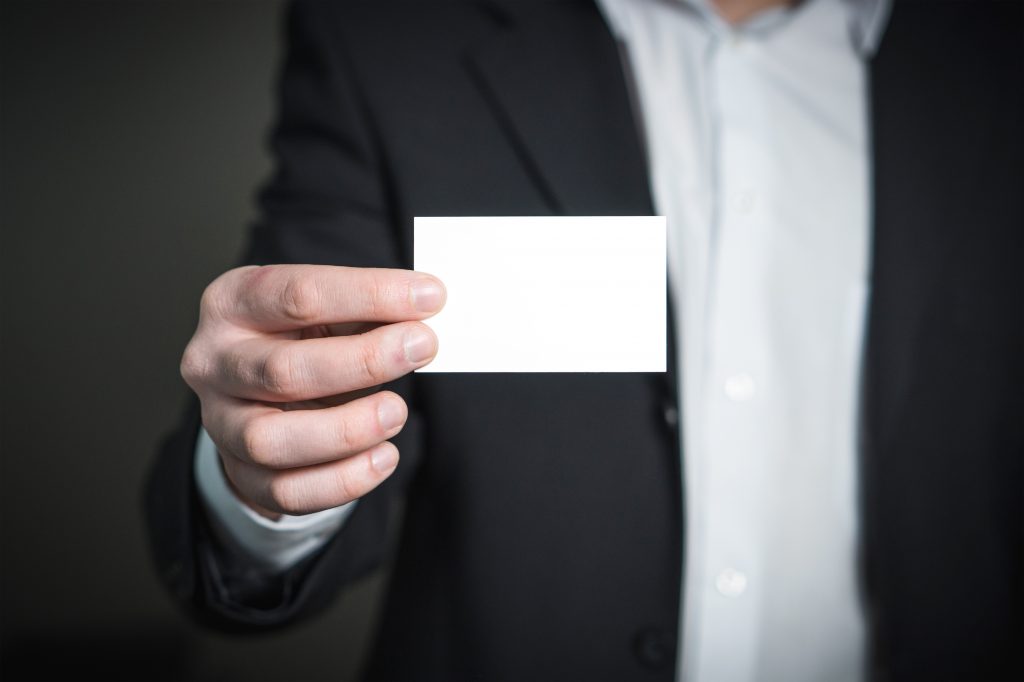 man holding blank business card