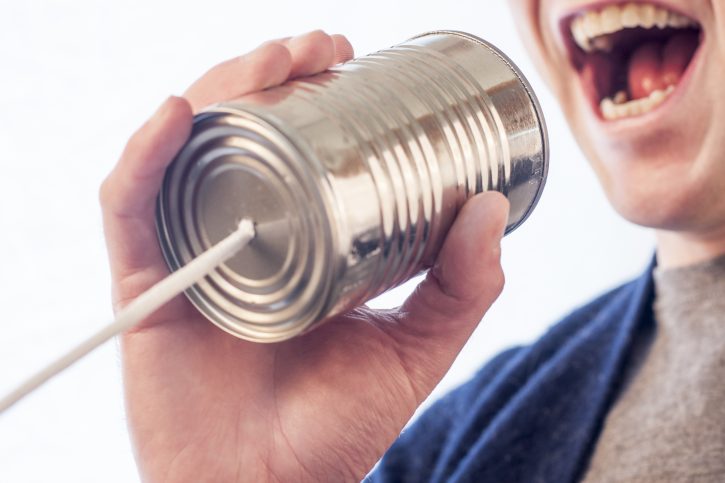 Man communicating via tin can